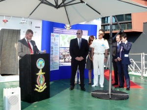 His Serene Highness Prince Albert of Monaco and Captain Tetsushi Mitsuya, commanding officer of the training ship Kojima of Japan Coast Guard, stand alongside Robert Ward, President of the IHO, during his remarks on board the Kojima